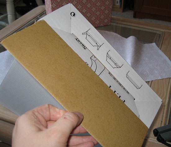 1. Cut out a piece of card board the same size as the base of the magazine file.